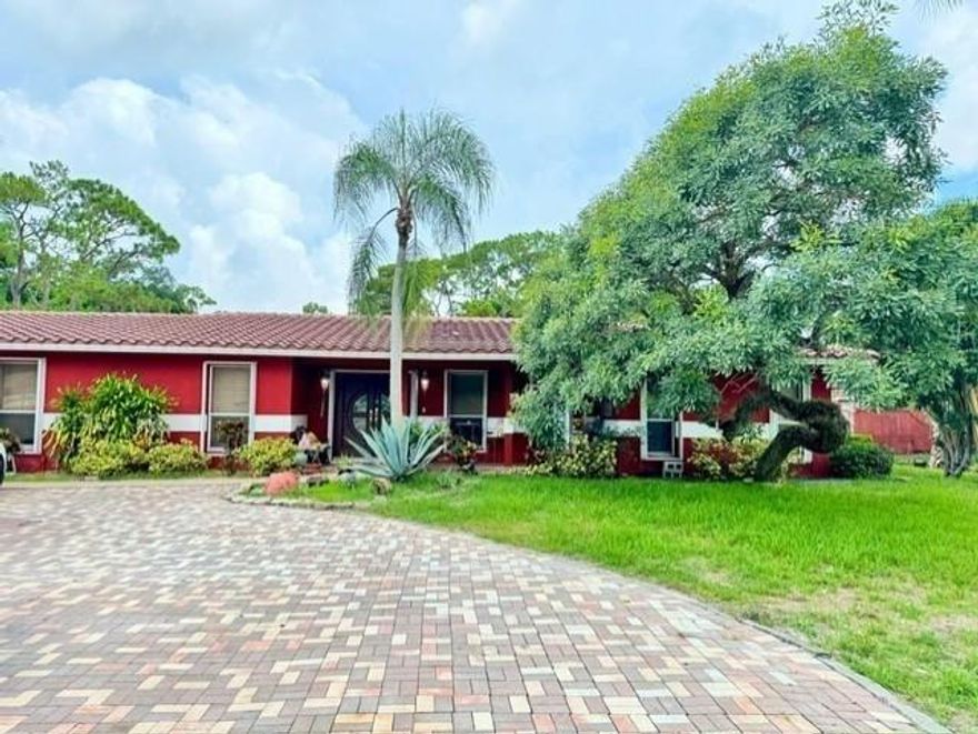 Owners downsizing! Welcome to this One-Story Ranch-Style home on a massive 59,370 sq ft lot in the highly sought-after, secluded equestrian community of Country Acres—no HOA! Enjoy the peace and quiet of country living while staying close to everything. The property offers a host of amenities including a private gated entry w/ intercom, full perimeter security fence, pool, pond, basketball & tennis courts. Inside, the quartz kitchen features a large countertop overlooking spacious family and recreation rooms. Beautiful porcelain tile floors flow throughout the home, with marble flooring in the bedrooms. Upgrades include modern windows with accordion storm shutters & a roof replaced in 2012. Bonus: A detached 1 bed / 1 bath guest house—perfect for in-laws, guests, or rental potential.