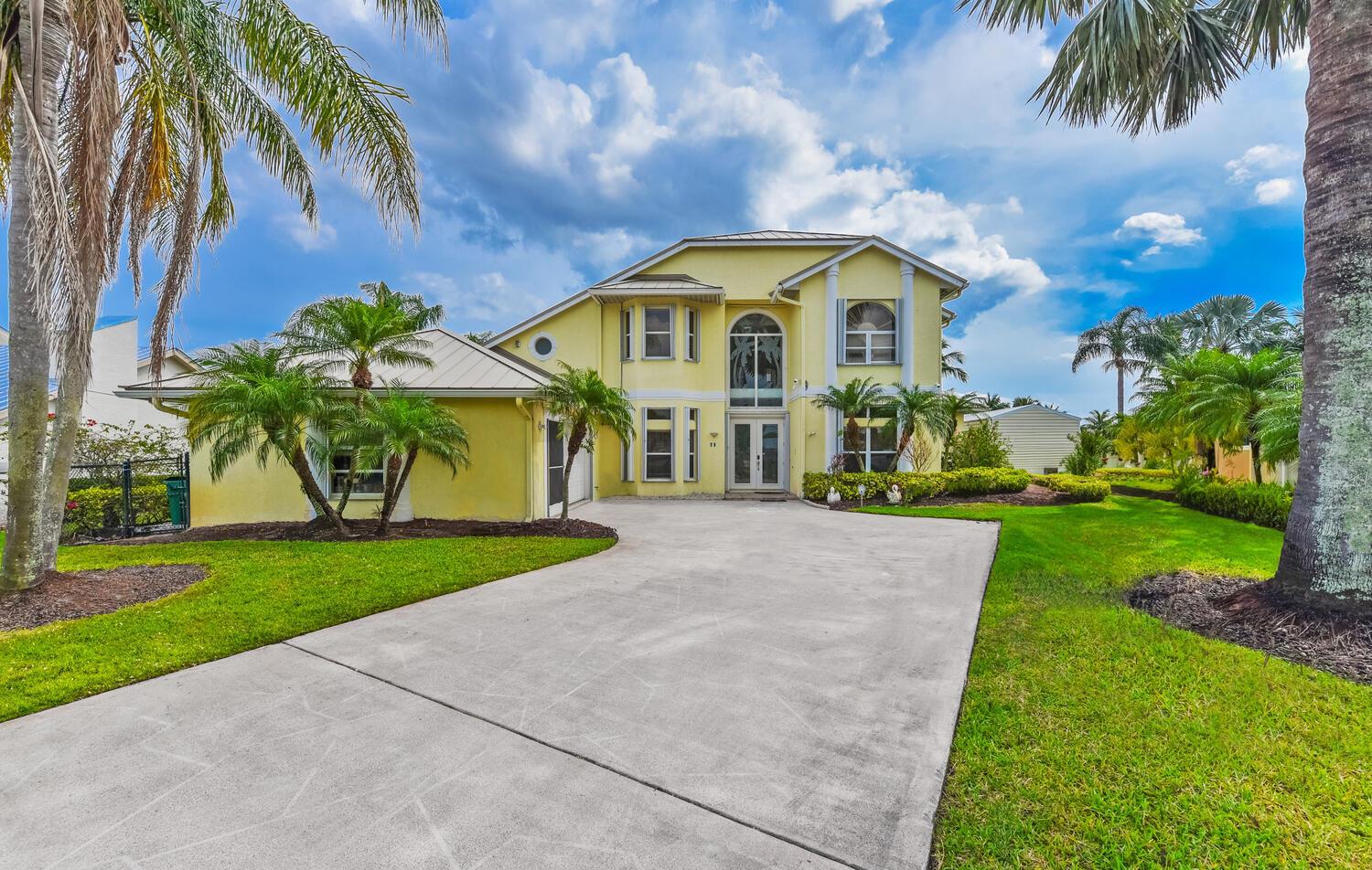 Enjoy tranquil water views and beautiful breezes from the back porch of this gorgeous home that sits on a cove in the St. Lucie River. This custom built 2 story 3/2.5 home has 180' of waterfront complete with dock, tiki hut and boat lift. OCEAN ACCESS. Amenities include full house generator, first floor master bedroom suite, office with french doors, oversized craft room with its own entry door which can be easily converted into guest suite, oversized air conditioned 2 car garage. Fully air-conditioned attic/storage. Accordion storm shutters. Metal roof 2016. Two A/C units 2014. Laminate and tile floors throughout and loft area and porch with amazing views of the river. Newly installed elevator. Some pictures have virtual staging.
