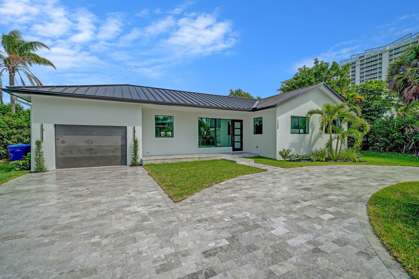 This stylish Singer Island retreat has welcomed celebrities, executives, and luxury travelers seeking the ultimate coastal escape. Just one block from the beach, this beautifully renovated 4-bedroom, 3.5-bathroom home offers over 2,000 square feet of thoughtfully curated living space. The split-bedroom floor plan ensures privacy, with a spacious primary suite on one side and three additional bedrooms on the other--perfect for families, guests, or a dedicated home office.The chef's kitchen boasts premium appliances, sleek finishes, and generous prep space--ideal for entertaining or relaxing nights in. Step outside into your private tropical haven, where a saltwater pool with a heater and a chiller awaits. Surrounded by a sun-soaked patio, it's the perfect spot to unwind under...