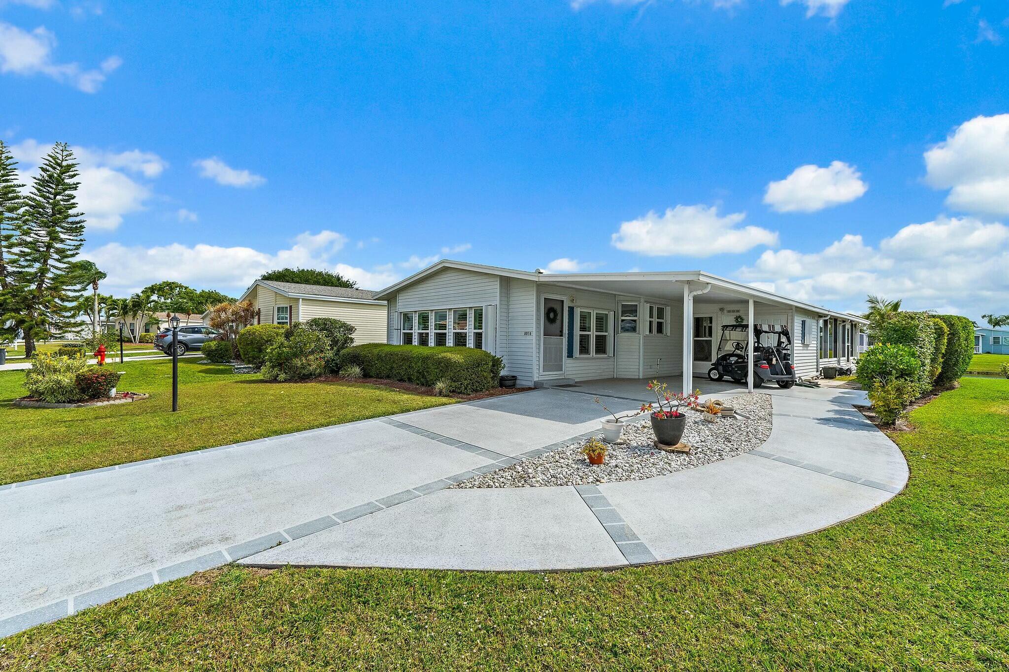 Land Owned Lakefront Beauty in Savanna Club 55+ Community - Don't miss this gem featuring 2 spacious bedrooms, 2 baths, a living room, and a family room, plus a glass-enclosed lanai with a mini-split A/C for year-round enjoyment. The updated kitchen boasts Corian countertops, home is fully furnished, turnkey, and beautifully decorated Tommy Bahama inspired decor and plantation shutters thru-out. Additional highlights include a 2020 roof, 2017 A/C, newer HWH, accordion shutters, a decorative drive and golf cart is negotiable, making it easy to explore this fantastic community.Ready for immediate occupancy--schedule your showing today!