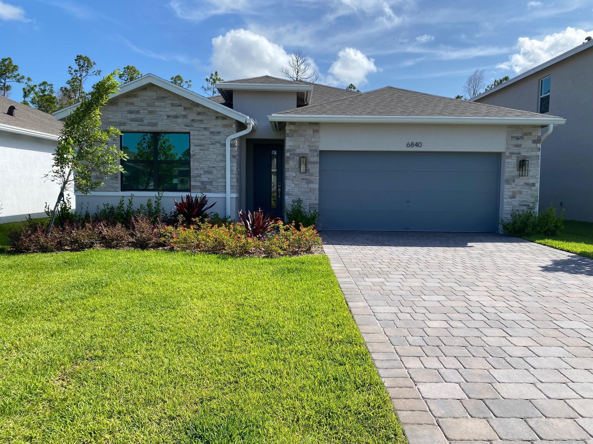 Stunning new 4BR/2BA Delray plan offers stylish single-level living with impact glass windows, soft-close cabinets, quartz kitchen countertops with waterfall edge, and wood-look porcelain tile throughout. Enjoy a frameless glass shower, spacious great room, and covered lanai--perfect for entertaining family and friends!