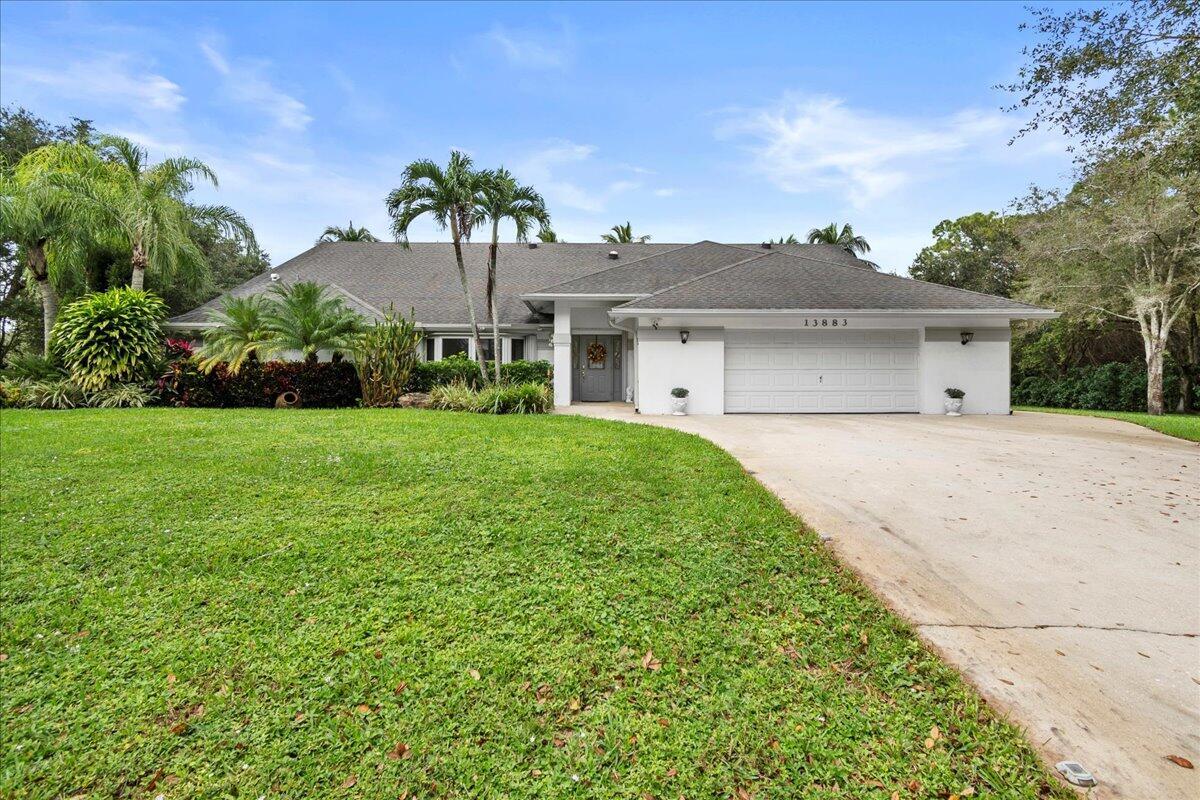 Don't miss this opportunity to own a unique, beautifully updated home in popular Acreage! This solidly built 4-bedroom, 3-bath home w/ a 2-car garage features a spacious pool with spa & waterfall, a large entertainment gazebo, and a fully fenced, landscaped yard w/ mature oak & fruit trees. Upgrades include a 2018 roof with extra foam insulation, new water heater, impact windows, impact solar tubes for natural light, vaulted ceilings, a spacious kitchen w/pull-out drawers, Corian countertops, stainless steel appliances, a wood-burning fireplace, French doors, spacious Loft, & a cabana bath. With ample space for your boat, RV, or horses, and a sprinkler system on well water, this property is ready to impress. Conveniently located near shopping, entertainment, & highways.