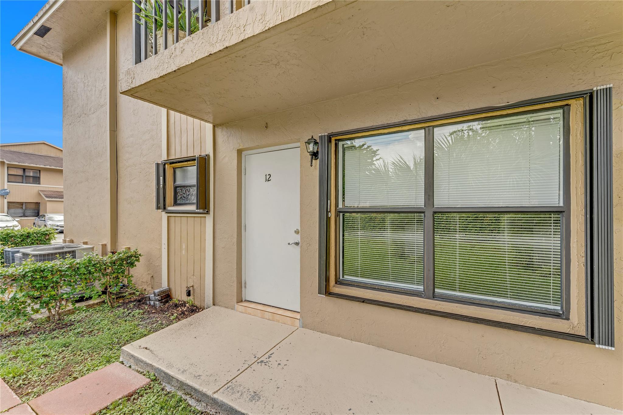 Spacious 2/2 Corner Unit in Prime Location! This well-maintained first-floor condo in the gated Lago Grande community features tiled flooring throughout, hurricane shutters, and an in-unit washer and dryer for added convenience. The bright corner layout offers great natural light and an easy move-in experience. Close to shopping, dining, major highways, and more. Don’t miss this great opportunity!