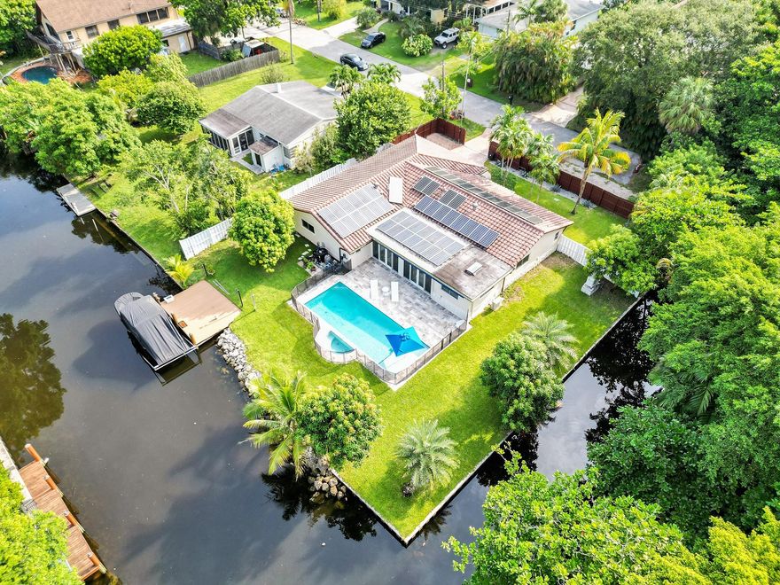 TOTALLY RENOVATED PRIVATE, TROPICAL, DOUBLE  POINT LOT WATERFRONT  HOME LOCATED IN CUL DE SAC W/ 215 FEET ON WATER.....NEW BOAT LIFT.....SALT WATER HEATED POOL....OCEAN ACCESS W/ 1  LOW FIXED BRIDGE W/ 6 FT CLEARANCE.....TOP OF THE LINE KITCHEN W/ 13 Ft QUARTZ CENTER COOK TOP ISLAND W/ SEATING FOR 8, BOSH & FRIGIDAIRE APPLIANCES OPENING TO  LIVING ROOM.....HI HAT LIGHTING & WIDE PLANTATION SHUTTERS  THRU-OUT, LG FAMILY ROOM & BONUS ROOM FOR OFFICE.....STUNNING  OVERSIZED MASTER BATH W/ QUARTZ COUNTERTOPS & DOUBLE SINKS, TOUCH LITE MIRROR, HUGE SHOWER W/ DECORATIVE WAVE TILE & GLASS TILE INSERTS,  DUAL SHOWER HEADS & H20 WANDS......ALL NEW 24 KW WHOLE HOUSE GENERATOR, RETRACTABLE AWNING, SOLAR PANELS & SOLAR HOT WATER HEATER....SOLID  WOOD FRONT DOOR & 2 CAR GARAGE DOOR ARE NOT IMPACT RATED