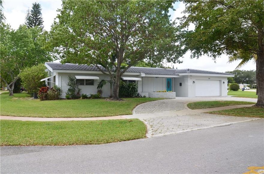 Spacious corner lot with 2 primary suites. One is convertible with own private entrance and bath. 4 bed / 3 bath. Stylish waterproof laminate flooring throughout. Circular driveway and 2 car garage provide ample parking, Ceiling fans in each bedroom & 2017 A/C guaranteed to keep you cool. LED lighting throughout means less hassle changing bulbs. Safety comes first with hurricane shutters and a hurricane garage door. Updated baths. Lots of storage including a large pantry & 2 linen closets. Nest wireless temperature control. Year round swimming with solar heated pool & covered outdoor patio! Sleek stainless kitchen appliances & granite counter top. Split bedroom layout allows for privacy. Bright, window-lined, family-dining combo overlooks pool & patio. Plenty of outdoor space! Barrel roof