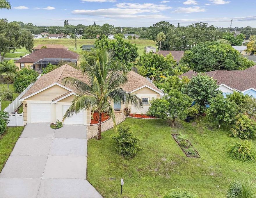Welcome to 1651 Alpha St NE, Palm Bay, FL 32907 -- a beautifully updated 3-bedroom, 2-bath home featuring an open floor plan with high ceilings throughout. Enjoy peace of mind with a new roof (2023), AC (2019), and newer water heater. The stunning renovated kitchen boasts granite countertops, modern cabinetry, and flows seamlessly into spacious living areas with laminate and tile flooring. The primary suite offers direct access to the backyard, a large bathroom with a tub and separate shower, and his-and-hers closets. Step outside to a gorgeous patio perfect for entertaining, surrounded by lush fruit trees including pear, ackee, banana, pineapple, jackfruit, lychee, orange, mango, and coconut--your own tropical paradise! Conveniently located near shopping, dining, and major roads, this home also sits within the Brevard County School District, close to Port Malabar Elementary, Stone Magnet Middle, and Palm Bay Magnet High School.