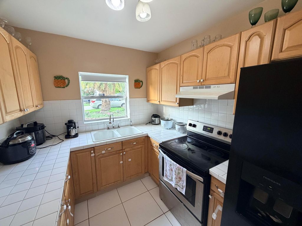 Photo of 208 NW Avenue H Place, Belle Glade, FL 33430 (MLS # B26036693)