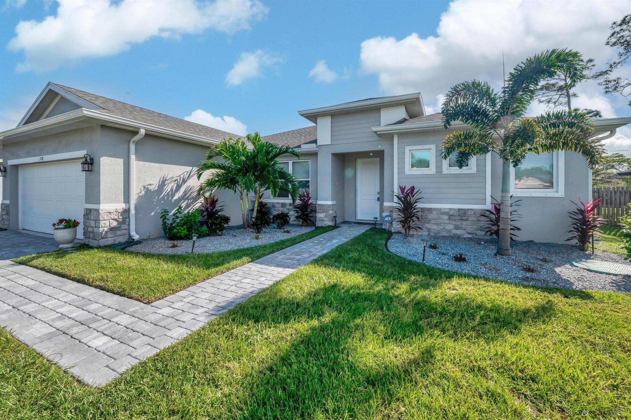 Welcome to this exceptional 3-bedroom, 2-bathroom home, meticulously crafted by Carharp Homes in 2022. Thoughtfully designed with modern living in mind, this home features tile flooring throughout, creating a sleek and cohesive aesthetic across the entire space. The heart of the home is the gourmet kitchen, where a stunning waterfall island makes a perfect gathering spot for family and friends. Outside, the home's curb appeal is enhanced by a pavered driveway and patio, seamless gutters, and a fully automated sprinkler system that makes maintaining the lush landscape easy and stress-free. Move-in ready and loaded with upgrades, this Carharp home offers an ideal blend of elegance, convenience, and high-quality finishes.
