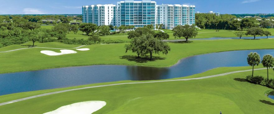 Exquisite 4th floor apartment in the luxurious Akoya Building of Boca West CC with 2 SPACIOUS EN-SUITE BEDROOMS, a den/office & floor-to-ceiling impact windows which frame PANORAMIC VIEWS OF MAGNIFICENT LANDSCAPES including lush fairways & a picturesque lake.  The GOURMET CHEF'S KITCHEN features Sub Zero & Wolf appliances, Italian cabinets, quartz counters & a large island with a seating area.  This stunning residence has large custom closets, power window shades & upgraded porcelain tile throughout, dual shades in the bedrooms. TWO BALCONIES WITH GORGEOUS VIEWS OF LANDSCAPES, SUNRISES & SUNSETS.  Two parking spaces: one which is PRE-WIRED for an ELECTRIC CAR CHARGER.  AKOYA IS THE RESIDENTIAL CROWN JEWEL of Boca West CC because of its contemporary interiors & exterior elevations,