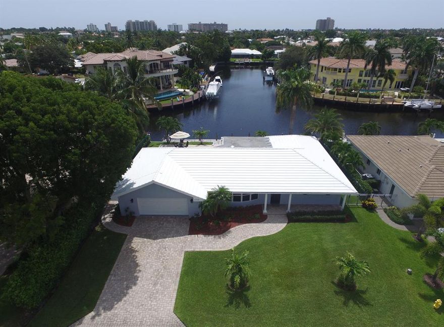 Boat Lovers Dream! Amazing water front lot. This house sits on T canal. Your backyard view is straight down one canal while also on another canal at the inter section. You can fit up to an 80ft boat. New single 50 amp service, newly dredged. New paint inside and out. New impact glass throughout. New wood plank style tile floors, Newly painted garage walls and floor. Stainless steel appliances, granite, Jacuzzi tub, newly landscaped. Minutes to the Lighthouse Point inlet. No fixed bridges. Ready for your personal touch to make this home.
