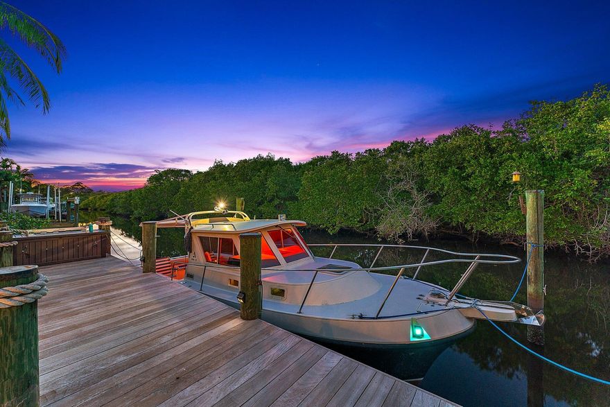 Boater's Paradise! STUNNING Waterfront & Preserve views! Your very own Tropical Oasis w/lush colorful plants, Fruit trees, Hardwood (IPE) Multi Level decking, Custom heated/salt water Pool, Brand NEW Pergola w/Trex deck & 62+ft Dock on a deep canal for your boating pleasure. Watch manatee & beautiful birds as you relax or fish by the water's edge. This Solid Built CBS 2 story Home has soaring 21 ft ceilings, Hurricane Impact Windows/Doors, Metal Roof & Solar Panels for Low Electric Bills! Features: Granite kitchen, laminate flooring, coastal color palette, 3.5 baths & beautiful views of the shimmering water & bountiful nature! The Open Floor boasts a chef's Kitchen, Dining Area & Great Room. Two Owner's Suites w/private baths & walk in closets, 1st Floor Primary Suite has sliders to an 1st Floor Primary Suite has sliders to an expansive Deck perfect for your morning coffee. 2nd story primary Suite boasts panoramic waterfront views & delightful covered Balcony. 3rd Ensuite Bedroom perfect for guests. Expanded Garage w/workshop