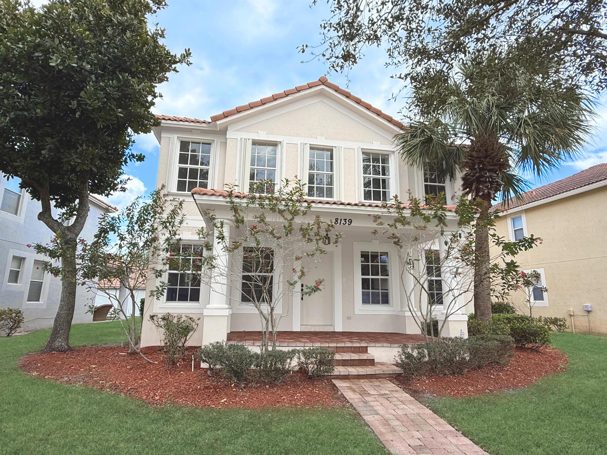 Dicover your oasis in Palm Beach Gardens! Sunlit 4-bed, 3.5-bath with large flex room/office, vaulted ceilings, automated blinds, new 2022 A/C unit, and expansive front yard. Kitchen boasts granite countertops, spacious island, premium double oven, and ample pantry space. Main-floor owner's suite offers private bath with jetted tub and generous closet space, while three additional bedroom upstairs provide privacy. Enjoy low-maintenance yard with screened rear patio and detached two-car garage, two-car driveway, and parking upfront. Perfectly located with quick access to turnpike, I-95, Garden's Mall (10 min), and PBI Airport and the beach (15 min). This home offers modern upgrades and unbeatable convenience. Experience luxury, style, and location in one exceptional property.