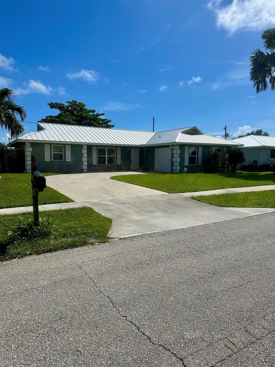 Welcome to this beautifully updated 3 bedroom, 2 bathroom single-family home with a one car garage in the heart of Lantana. Step inside to an inviting open floor plan that seamlessly connects the living, dining and kitchen areas-ideal for both everyday living and entertaining. Recent upgrades include a metal roof and air conditioner (2019), as well as full hurricane protection with impact windows throughout for peace of mind. The kitchen features a new refrigerator and stove, ready for your culinary creations. The generously sized fenced in backyard offers ample space for outdoor activities, entertaining and gardening. Located just minutes from major highways, the beach and shopping. Schedule your showing today to make this fabulous home yours!