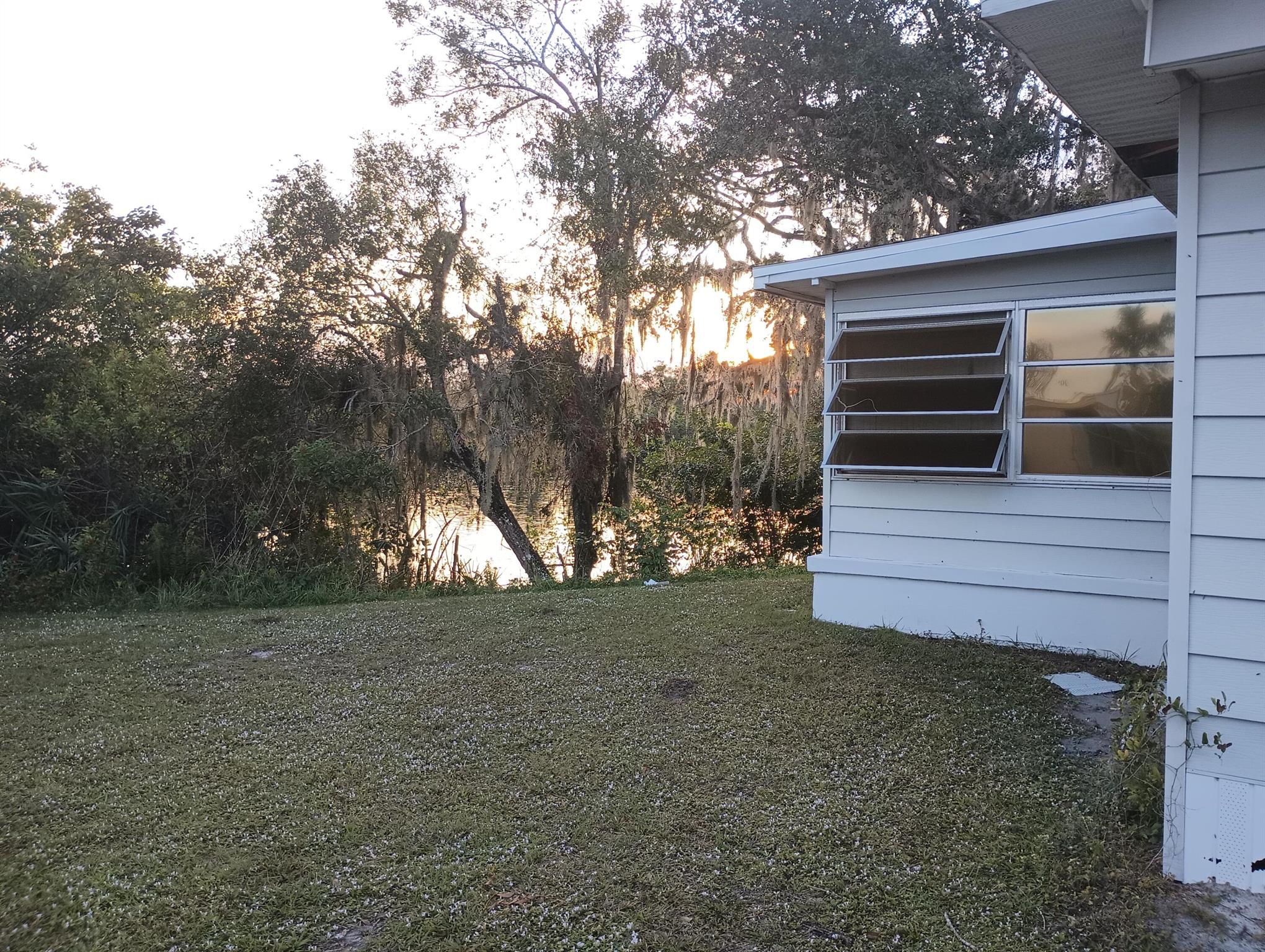 THE best lot in all of Spanish Lakes Perfect fishing and crabbing spot 20 ft from the back door. NO BODY HAS FISHED THIS SPOT IN 10 YEARS Very private large trees and foliage protects your private beach. The home is currently occupied but needs some more work to make perfect. Owner has been improving the exterior and interior. Please note Spanish Lakes will not allow a Container Home anywhere they are planning to put Condos. The home passed the exterior inspection last month.Market rent (new owner): $1,483.06 a month for 12 months. You just have to rent the land from Spanish Lakes HOME will be sold to the highest bidder August 2nd 2025 This is a million dollar location. Reserve $2,500.00 Neighbors have put in white PVC 4 inch posts and anchored long term