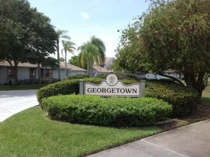 Pride of ownership shows in this pristine 2 bedroom 2.5 bath townhome located in Georgetown at Heritage Ridge.  Recent upgrades include, new  hardwood floors, new carpet, accordion hurricane shutters.  Oversized garage with pull down stairs & attic storage. Entry courtyard area plus enclosed rear lanai with impact glass giving living room additional square footage. A covered balcony off the master bedroom offers lovely garden views. Community offers 2 pools, spa/hot tub, tennis, Pickleball & public golf course.