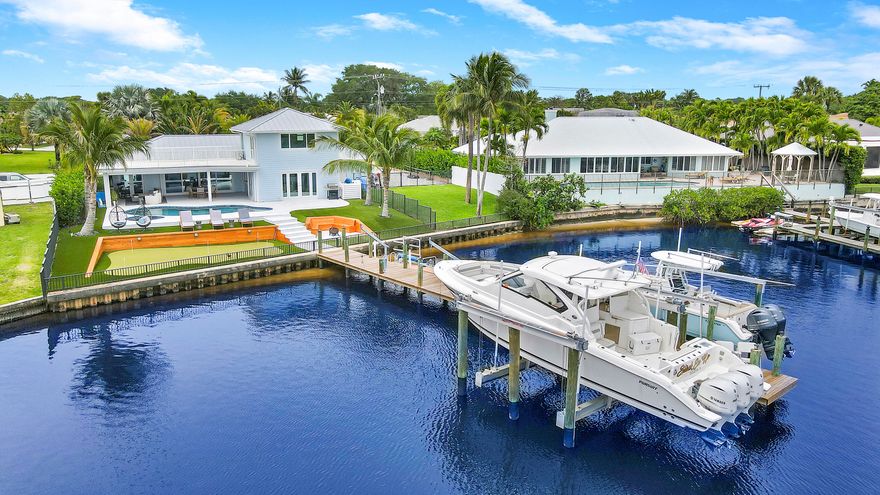 Waterfront home in the community of Turtle Creek! On the North Fork of the Loxahatchee River with new dock with double lifts (holding 8K & 32K pounds) with brand new motor. New metal roof installed 2021. All impact windows & doors. New pool, turf landscaping, putting green, fire pit, fully fenced yard and water views from every room make the home the ultimate entertainer's paradise! Plus recently installed automatic hurricane screens & AC/heat system for the patio allows patio to become a fully enclosed extension of the living room for additional entertaining space. En-suite primary bedroom, second bedroom & half bath on 1st floor. Large third bedroom with full bath & open terrace on the second floor make the perfect upstairs, private guest suite. & enjoy Martin County taxes!