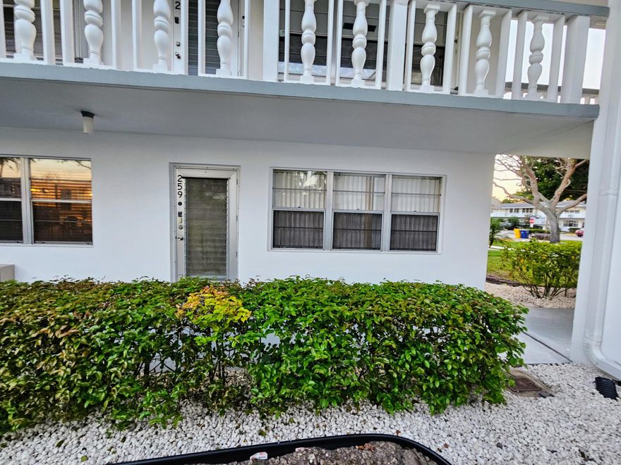 NEW Roof and Central AC!  Step into this inviting first-floor corner condo and immediately feel at home.  The open layout highlights sleek ceramic tile flooring, tastefully updated bathrooms, new lighting in the dining area and a new ceiling fan. Enjoy tranquil Florida evenings from your spacious patio. Community laundry and mail rooms are conveniently located just steps from your door.  No smoking. Outside, discover an active 55+ lifestyle with 24-hour manned security, a courtesy bus, and endless amenities including a clubhouse, fitness center, indoor and outdoor pools, tennis and pickleball courts, shuffleboard, sauna, and a movie theater. Perfectly situated near the Okeechobee Blvd gate, you'll find shops and restaurants plus quick access the turnpike.