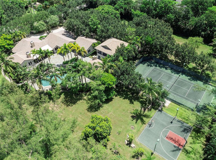 Total perfection in this one-of-a-kind Private Estate in Parkland! Main house w/ 6 bedrooms + office + den & 7 baths. Guest House w/ 3 bedrooms & 2 baths. All located on 3 beautiful acres of landscaped luxury! The ultimate family resort w/ lighted tennis court, basketball court & huge open field to play. Amazing covered gazebo w/ two grills, fireplace, TV & view of hotel-style pool & hot tub!  Gorgeous custom kitchen w/ premium Wolf & Sub-Zero appliances, 2 dishwashers, 2 ovens, 2 wine coolers, built-in Miele & much more! Built in 2009 w/ elegant finishes, stunning millwork, impact windows & doors, wood beams & floors. Property has mango trees, lime trees, banana trees -  enjoy your own tropical oasis in the exclusive Ranches! Whole home generator, plenty of room for stables. No HOA.