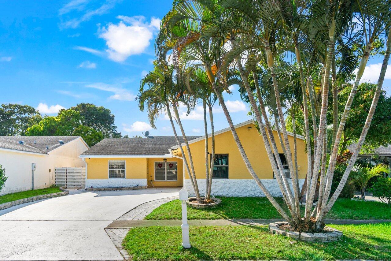 Look no further at this bright and airy three-bedroom two bath plus den home. Located in the center of West Lake Worth this split floor plan home features an extensive driveway, generous living room, spacious eat-in kitchen with a gas stove and stainless-steel appliances. Primary bedroom has a walk-in closet, step-in shower, and a welcoming bathtub. Outside you have a fully fenced in yard with pavers perfect for hosting or relaxing out back with waterfront views in the distance. Other features to take note vaulted ceilings, spacious guest bedrooms, an abundance of closet storage, and large two car garage. This home is a great opportunity to settle quick and conveniently located by shopping and multiple restaurants. You do not want to miss out on your chance to make this your home.