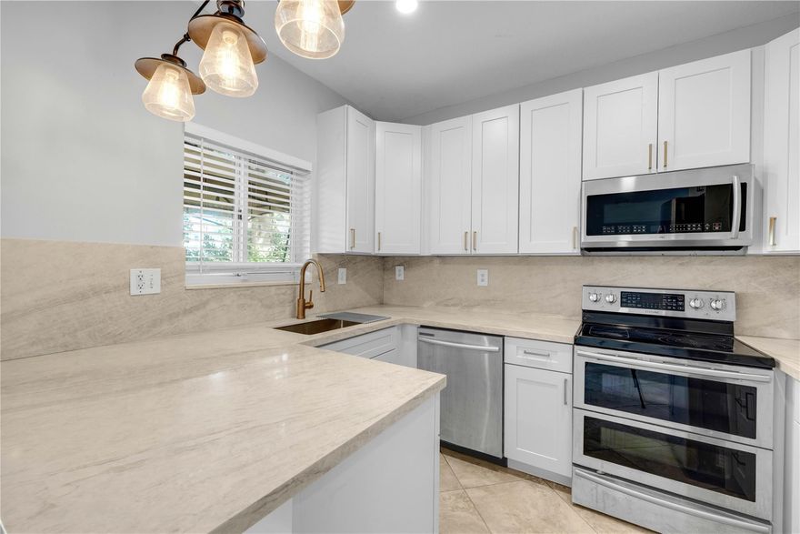 Beautifully renovated 2 bed, 2.5 bath townhome with a spacious den easily convertible to a 3rd bedroom. New roof with 10 yr warranty, new soft-close shaker kitchen cabinets, quartz countertops & full backsplash, updated dimmable LED lighting throughout, & freshly painted interiors. The primary suite features a fully remodeled spa-style bathroom, upgraded walk-in closet with built-in systems, & warm wood flooring throughout the upstairs. Newer kitchen appliances, washer/ dryer are only 2 years old, smart Nest thermostat, & Ring cameras. Balconies and decks have been refinished and beautiful outdoor lighting in front. Low HOA just $200/month. Move-in ready, modern, and beautifully updated in a highly desirable location. Some photos have been virtually staged.