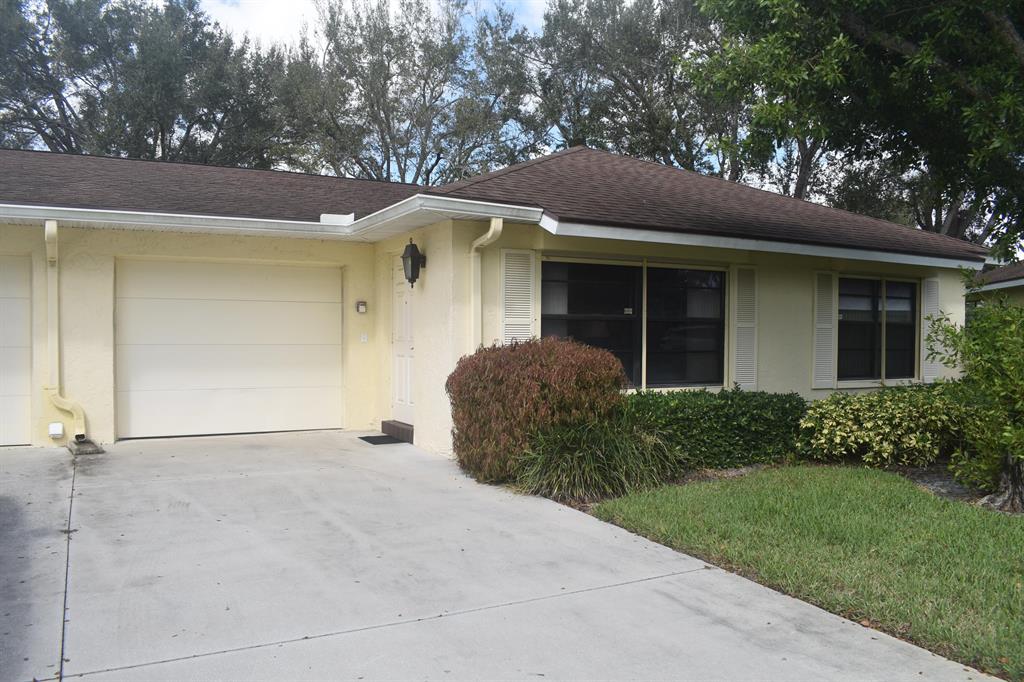You won't want to miss this one very clean with tile in main rooms and laminate floors in both bedrooms. It also has roll down shutter withthe hand cranks on the inside. The shutters in Florida room pull down and have braces Thereis a garden view in the back with small canal.Very nice pool at clubhouse, Clubhouse is beingremodeled. There is a Bocce Ball court underan awning Close to shopping and restaurant'sand short drive to the beach.