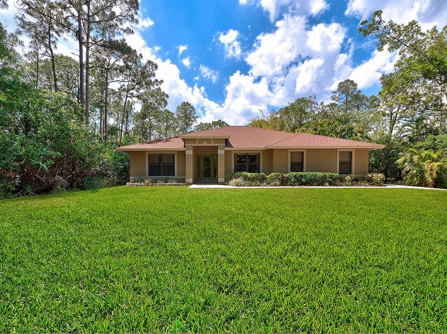 Welcome home to this beautifully maintained 4 Bed/ 2 Bath CBS  pool home.  Located on a paved road, situated on 1.2 acres, has a concrete drive and is completely fenced. The home boast a split floor plan and large rooms.  Wood Cabinets, granite counters and stainless steel appliances in the kitchen. The L shaped breakfast bar is 12' x 6'  and offers plenty of seating and excellent for entertaining. All hallways and door openings are wheelchair accessible.  Large master suite offers walk-in closet, large master bath with soaker tub and walk in shower.  2nd bath offers easy access to pool and patio.  Large screened patio and pool area w/ an outside shower.  Sheer descent waterfall offers relaxing sounds.  Home includes a generator and FPL surge protector. New hot water heater installed 5/18