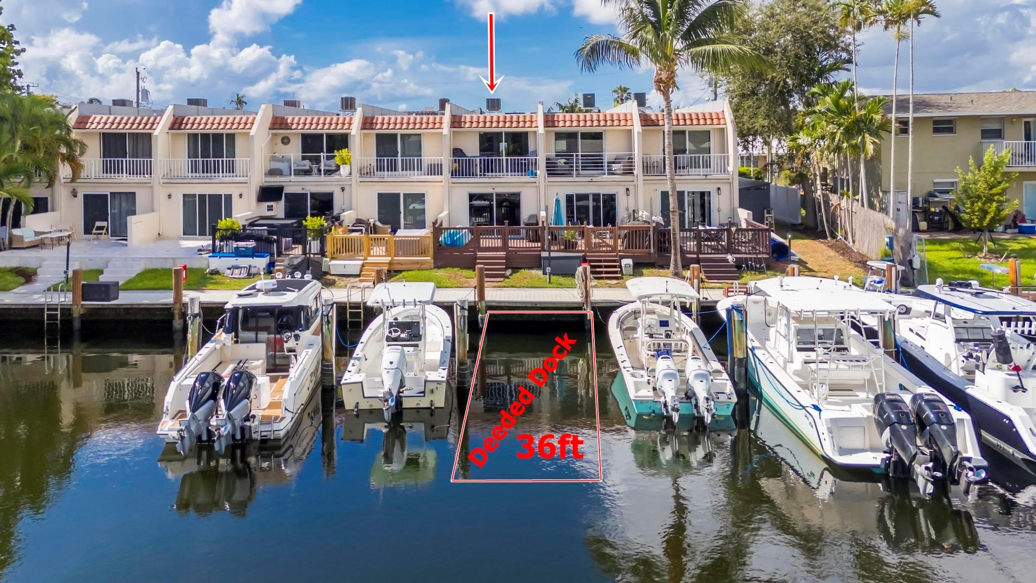 Beautifully remodeled 2BR/2.5BA waterfront townhome just minutes from the Intracoastal/ocean with a deeded dock to accomodate a 36ft boat that includes water & electric! Features include large wood patio with expansive water views, tile floors downstairs, laminate upstairs, custom wood cabinets, quartz counters, and stainless steel appliances. The primary suite offers a private balcony, updated bath, and ample space. Enjoy a full-size washer & dryer, 4-year-old roof, recently replaced cast iron pipes, 2 assigned parking spots. Low-maintenance coastal living with an unbeatable $250/month HOA, Move-in ready—perfect for boaters or anyone seeking a stylish waterfront lifestyle!
