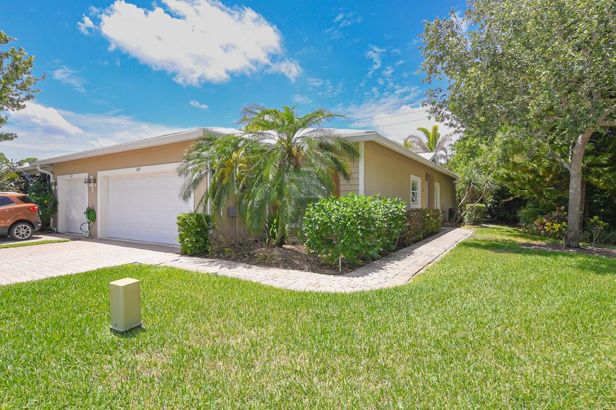 Gorgeous 2 bedroom, 2 bath, 2 car garage end villa with 2023 Metal Roof and Impact windows and sliding glass door.  Freshly painted and new LVP flooring.  Split floor plan with an office/den area.