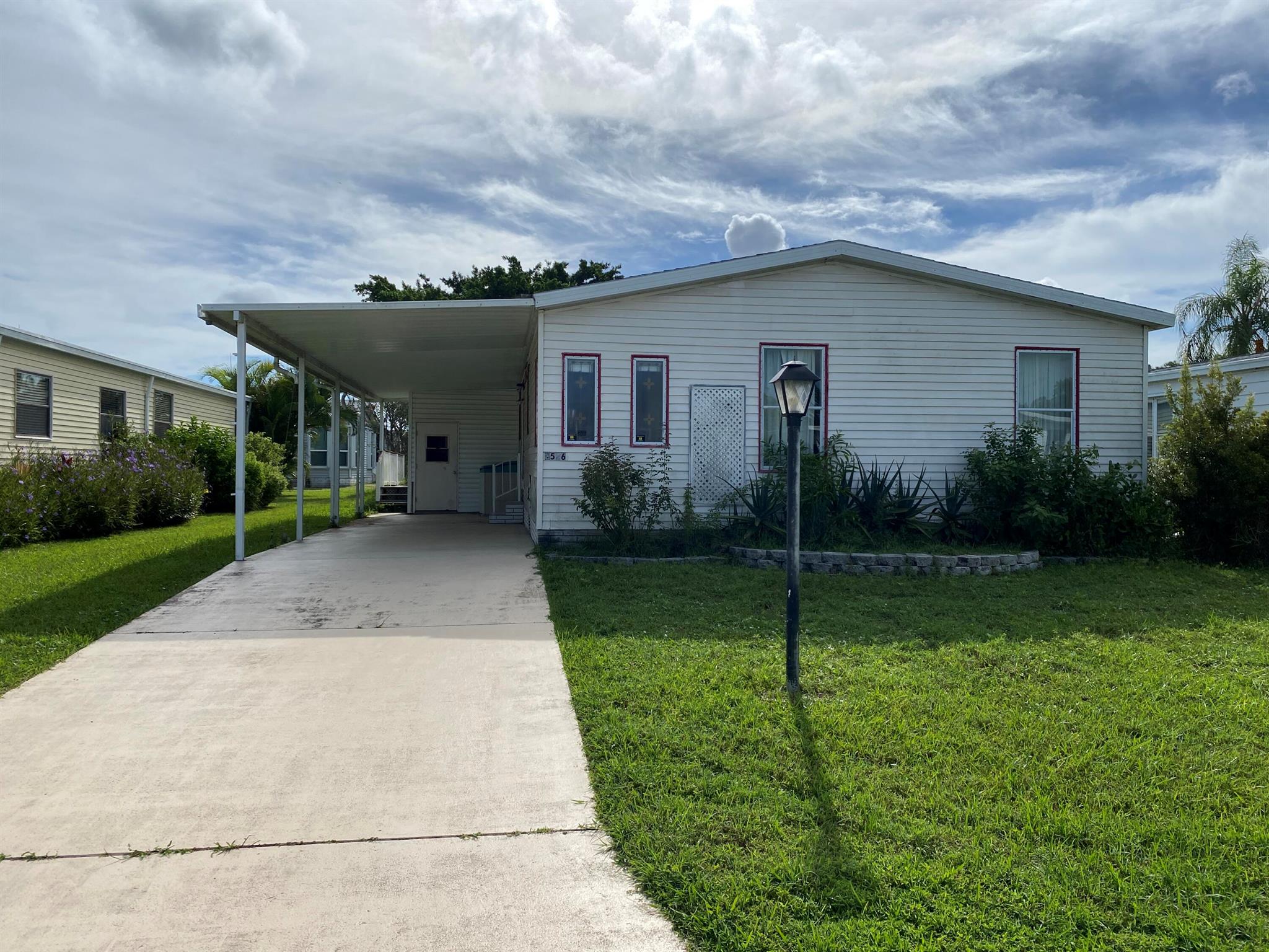 Mobile home located in Savanna Club where you own the land!  A unique resort lifestyle, 55+ community, with amenities including an 18-hole golf course, Performing Arts Center, four fully staffed clubhouses, a Tennis & Fitness Center and many social events. and just 20 minutes from the ocean. The property is situated on a quiet cul-de-sac street, surrounded by well-maintained properties and great neighbors!  It features a large attached carport and open wood deck.  Large open floor plan with big living room, dining room and kitchen with ample cabinets/counters.  Three bedrooms plus den, two full baths and laundry room.  This property needs significant repairs, so cash offers only, and sold as-is, all room sizes are aprx. Buyer will be required to sign a HHA for exterior code violations.