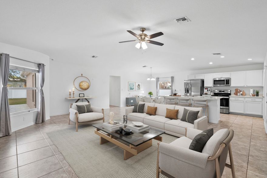 Impeccable 2021 CBS home in Port St. Lucie situated on a 0.25-acre lot with NO HOA and loaded with upgrades! Open floor plan with no carpet and tile floors throughout. Modern kitchen with Corian countertops, upgraded cabinets, and stainless appliances. Vaulted ceiling enhances the spacious feel. Full impact glass and solar panels provide efficiency and storm protection. Smart lights and switches plus an A/C UV light purification system add comfort and convenience. Professionally fenced yard and covered paver patio are perfect for outdoor living. Custom primary closet, security cameras, EU garage outlet, and generator relay complete this move-in-ready home. The entire home is solar.  Currently electric bills are no more than $30 per month wihich is the grid connection charge.