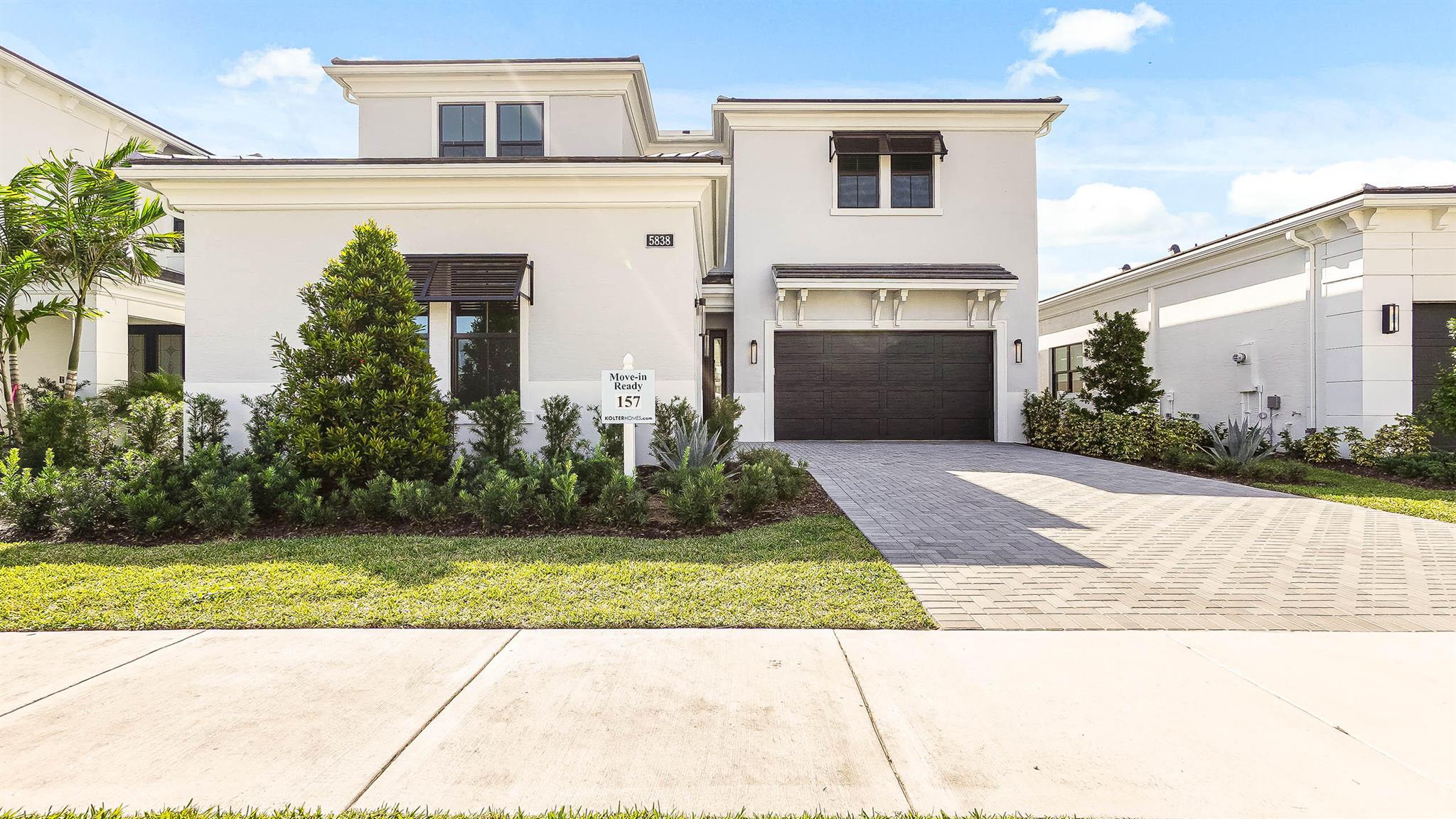 **New Construction - Move In Ready** This brand new Mondrian floorplan is situated on an interior waterfront homesite within Artistry Palm Beach. This home offers 4 bedroom suites, each with their own bathroom, an additional half bathroom and a split-3 car garage. This Mondrian also includes gas cooking in the kitchen, 2nd tier upper cabinets, quartz backsplash, a waterfall quartz kitchen island and under cabinet LED lighting. The house has the loft converted to a larger game room upstairs, a gas connection for a future pool heater, as well as gas, electric and water connections for a future outdoor summer kitchen.
