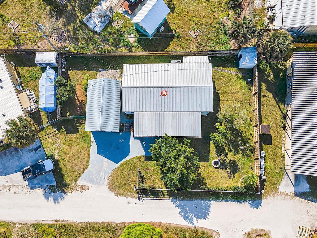 Old Florida welcomes you home. Spacious mobile home with detached garage on your private fenced-in lot, you own the land! No HOA. Home is complete with 2 bedrooms, 2 baths, a screened-in porch, laundry and plenty of space to spread out. Located in Hobe Sound down a quiet street, surrounded by nature, close to restaurants, shopping and minutes to the beach. Financing available.