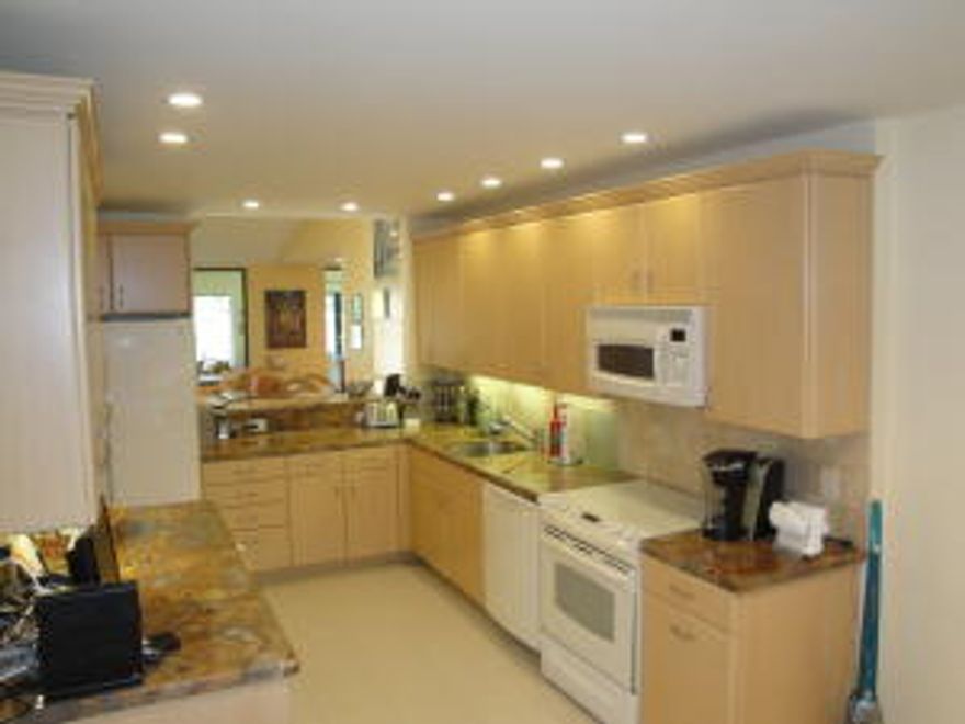 Light, Bright, Vaulted Ceilings, Expansive Golf and Lake Views. The ULTIMATE Eastgate Hunters Run Condo.New Kitchen with Large Pass Thru, and Gorgeous Granite.Neutral Tile Through Out Living Areas, Updated Bathrooms, Frameless Shower Doors, Plantation Shutters, Recessed Lighting, Privacy Door For Guest Suite, Granite Bar in Den/3rd Bedroom with Accordion Door, Professionally Outfitted Closets, Impact Glass Enclosed Patio, Accordion Hurrican Shutters .  Elevator Included.