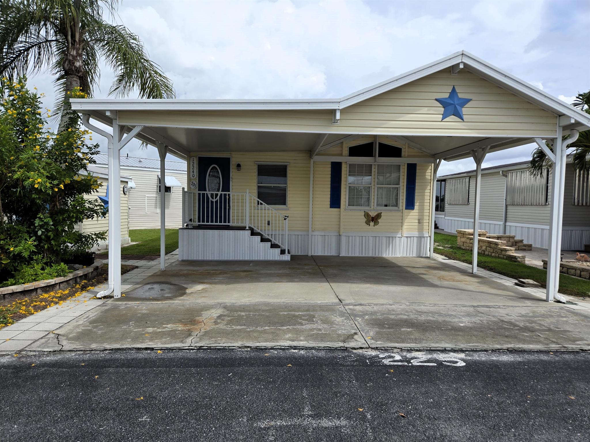 BLUE CYPRESS GOLF & RV RESORT - This waterfront 2 bdrm 2 ba home has 968 sf under air. Kitchen is a dream with tons of storage and wide open space for entertaining. 2nd bdrm/den. Ceiling fans throughout the home. Upgrades include roof, cabinets, appliances, AC w/duct work and dock; all within the past 5 years. Indoor utility room. Enclosed Florida room is perfect for den/craft room. Back patio w/pavers provide outdoor entertaining area overlooking pond w/shared dock. Concrete walkway surrounds home. Carport provides covered parking and will accommodate boat. Shed/Workshop perfect for storing all your outside equipment. Active 55+ community with pool, golf and boating activities. This one is a gem!