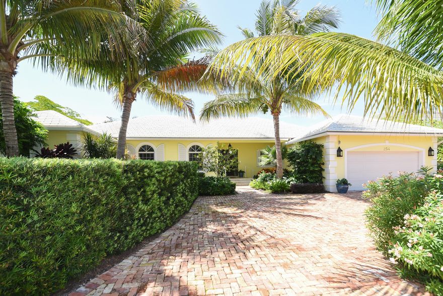 Popular PB north end beach access comes with this one story home on a 13,490 SF. Brand new wood burning fireplace in the living room, two master suites plus 2 en-suite bedrooms, high ceilings, all impact windows/doors, eat-in kitchen, formal living & dining rooms, formal entry leads to open view of the covered loggia, 34x20 heated pool and spacious beautifully landscaped yard.  Easy access to the ocean and the lake trail, and across the street from the Town's Arboretum.