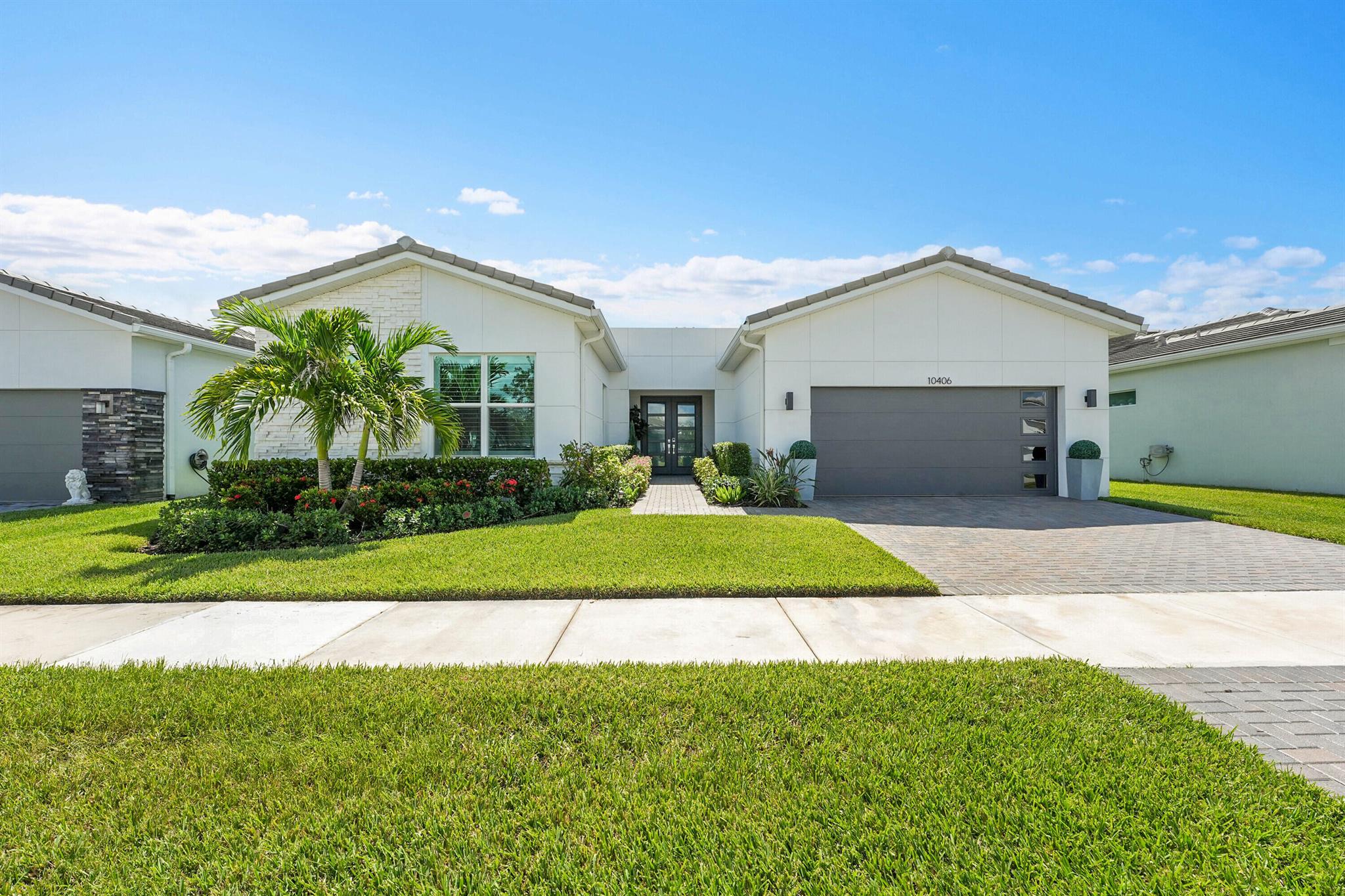 Built in 2022, the Lakefront single-family home offers modern luxury living with a spacious open-concept design. Featuring impact windows and doors, a double-door entry, and a 2-car garage. The gourmet kitchen overlooks the family area and includes a large cooking island, wood cabinetry, gas stove, spacious pantry, and a separate wet bar with a wine cooler--perfect for entertaining. Two master suites, each with walk-in closets, and spa-like bathrooms with dual sinks. Primary bath with oversized walk-in showers with double shower heads. The primary master retreat also offers space for a cozy sitting area. Laundry room with storage and an enclosed, screened-in patio with a built-in grill, overlooking a spacious yard with room for a pool. Enjoy