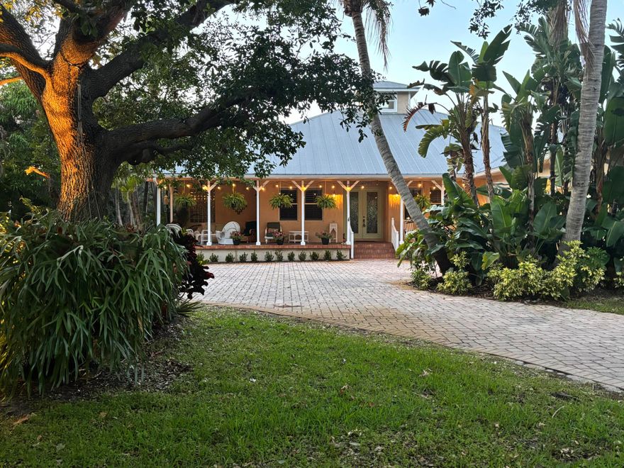 Tucked behind walls and gates, this private estate retreat sits on nearly an acre of lush, tree-canopied grounds in one of Stuart's most desirable locations.  Backing to Sailfish Sands Golf Course, the property offers a rare combination of privacy and openness—expansive green views with no rear neighbors and a uniquely dynamic backdrop of planes passing overhead in the distance. Inside, you'll find a spacious, light-filled layout with vaulted ceilings, a split floor plan, and thoughtfully designed living areas ideal for both everyday living and entertaining. The home features 4 bedrooms, 3 full baths, including a private ensuite, along with a chef-style kitchen and generous living spaces.  Step outside to your own secluded setting with a pool, mature landscaping, and plenty of room to  entertain, or simply enjoy the peace and privacy.  With a 3-car garage and space for RV or boat parking, this property offers flexibility that's hard to find.  Located just minutes from downtown Stuart, beaches, dining, and shopping—this is a rare opportunity to own a gated sanctuary with land, location, and lifestyle.