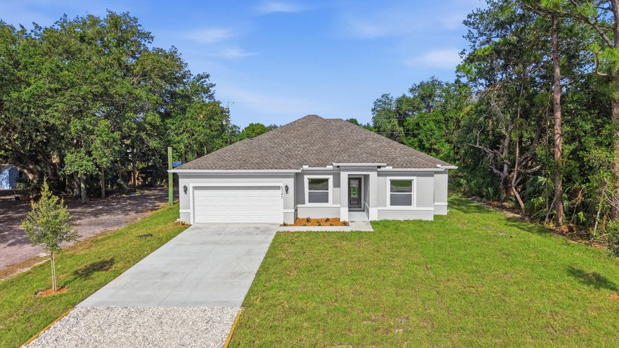 MOVE-IN READY! This beautifully 4-bedroom, 2-bath home by OH Housing offers modern design and premium finishes throughout. Features include quartz countertops, tile flooring throughout the entire home, 42-inch soft-close cabinetry, and impact windows and doors for added style, efficiency, and peace of mind. The spacious open split floor plan is enhanced by impressive tray ceilings, creating a bright and inviting atmosphere. The Owner's Suite features a spa-inspired shower and an oversized walk-in closet. Attached 2-car garage, no HOA, and plenty of space to park, play, and enjoy FL living.