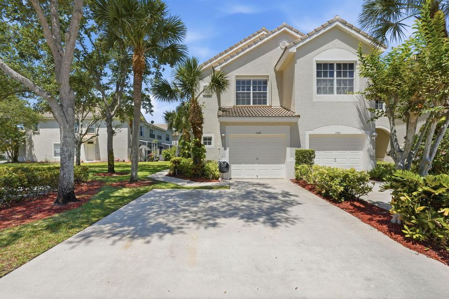 Beautifully updated corner unit featuring porcelain tile on the first floor and laminate flooring upstairs. The kitchen is upgraded with quartz countertop and black stainless steel appliances. Large sliding doors open to a private patio with a lake/nature preserve view. Includes a 1 car garage and a 2-car driveway with additional guest parking located next to the unit. Situated on a corner lot with open green space right beside the home. Conveniently located just minutes from Palm Beach International Airport, The Mall at Wellington Green, CityPlace, and some of South Florida's beautiful beaches.