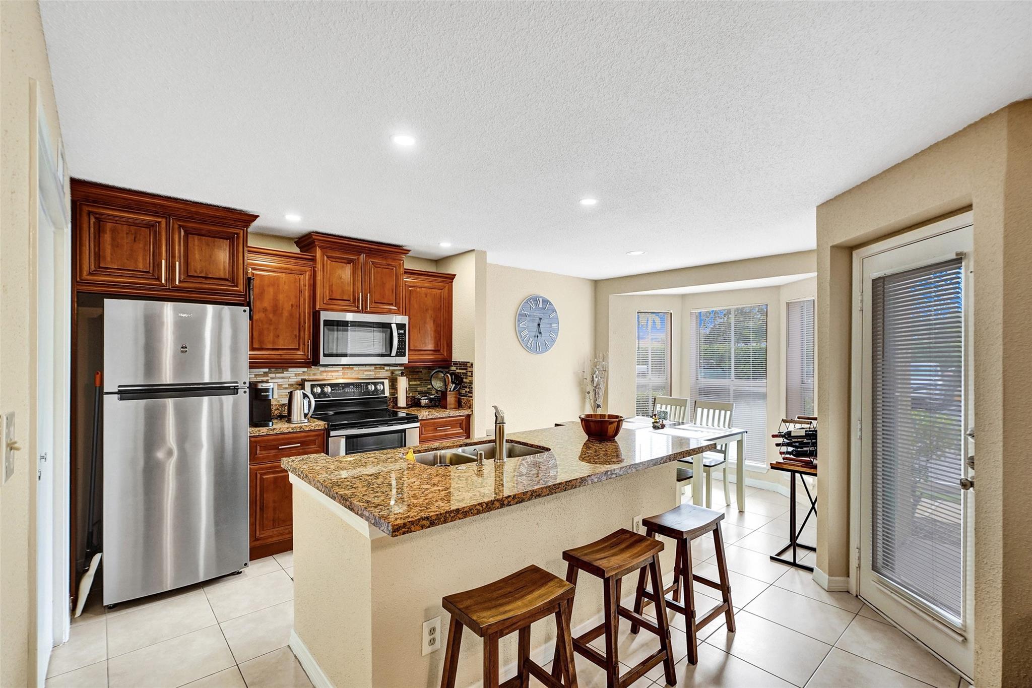 The absolute nicest condo on the market right now! Extremely convenient 1st floor unit with large covered patio. Featuring a new AC & new water heater with tile throughout the entire unit. Cherry wood kitchen with 1-level kitchen island. New Stainless Steel appliances in the kitchen have barely been used. New washer & dryer. Bathroom features travertine tile w/ cherry wood vanity. Oversized walk-in closet in the generously-sized bedroom. Association has plenty of reserves and is approved for 3-5% down payment! INVESTOR FRIENDLY - Can rent right away up to 2 times per year, 6 month minimum. Schedule your showing ASAP!