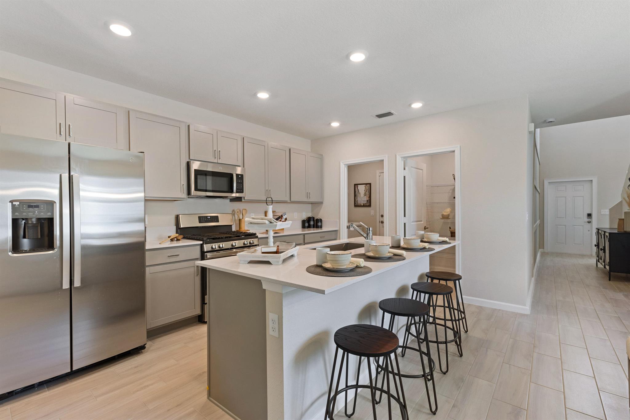 This stunning two-story, 5-bedroom, 2.5-bath home offers an open-concept layout, seamlessly connecting the kitchen, dining, and living areas for effortless transitions. The first-floor owner's suite provides added privacy, while the second floor features 4 additional bedrooms and a cozy loft. Enjoy outdoor leisure on the ready-to-use patio. The home includes a convenient two-bay garage, stainless steel appliances, a gas range, quartz countertops, upgraded light fixtures, and a Ring doorbell system. **Neighborhood includes a beautiful clubhouse, fitness center, community pool, pickleball courts, playground, and more! This is an incredible opportunity to make this beautiful house in this lovely neighborhood your home!** Photos are for illustrative purposes only.