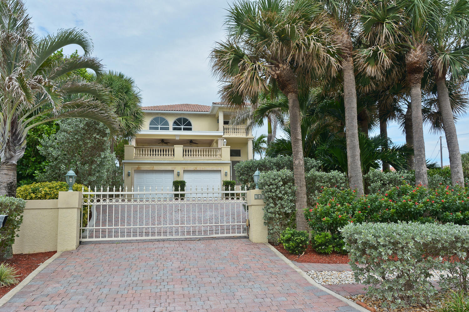 CUSTOM BUILT Mediterranean private gated enclave with Ocean directly across the street. Drive through wrought iron gate with Lighted pillars to enter this sun filled two story single family home. Enjoy breathtaking ocean views from beautiful impact glass windows and multiple balconies with balustrades & columns. Spacious new kitchen has fine wood cabinetry, over sized butcher block island with extra sink and granite back splashes. Master bath has double vanity and spa tub/shower and separate shower. Oversized 2 car garage with storage. Don't miss this opportunity to live and entertain in paradise across the street from the beach.