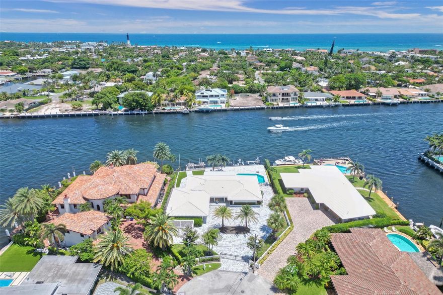 A true boater’s paradise, where luxury living meets waterfront bliss! This stunning gated estate nestled on an expansive 14,367 sq. ft lot with 100 ft of pristine Intracoastal frontage, in a no-wake zone, minutes from Hillsboro Inlet. Located on a cul-de-sac, this updated home, built on pilings, boasts a motor court/circular driveway, new pavers, a 2-bay garage, and a whole-home generator. Additional highlights include a chef’s kitchen, an office/den, a smart home system, new ACs and appliances. Step outside to enjoy a new composite dock complete with 2 boat lifts and a jet ski lift, a sparkling new saltwater heated pool and a covered lanai, perfect for entertaining. With its prime location and unparalleled amenities, this gem is a must-see for those seeking the epitome of coastal living.