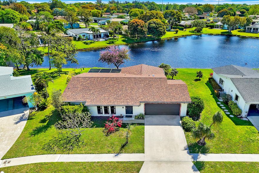 Experience lakeside living at its finest in this charming 2BR/2BA waterfront home with a 2-car garage in Coco Wood Lakes — one of Delray Beach's most convenient, active-adult & pet-friendly communities near Atlantic Ave and the beach. Thoughtfully updated with a New Roof (Nov 2025) and Complete Hurricane Impact Windows, this move-in-ready home offers peace of mind and low maintenance. Relax on the large screened lakeside patio with serene water views, enjoy bright open living spaces, and benefit from a low HOA that includes cable, internet and community amenities. Ideal for buyers seeking coastal convenience and an active, friendly neighborhood. Some photos virtually staged. Community & Location Coco Wood Lakes is a pet-friendly 55+ community of single-family homes with no mandatory memberships and low HOA fees ($204/month) covering cable, internet, amenities, common areas, property management, trash, sewer, and reserve funds. Residents enjoy a clubhouse with a fitness center, theater, billiards and card rooms, and an outdoor pool and spa (spa replaced spring 2025). Rentals are permitted immediately, up to twice per year, with a 90-day minimum. Ideally located just five miles from the ocean and downtown Atlantic Avenue, with convenient access to dining, shopping, and medical services.