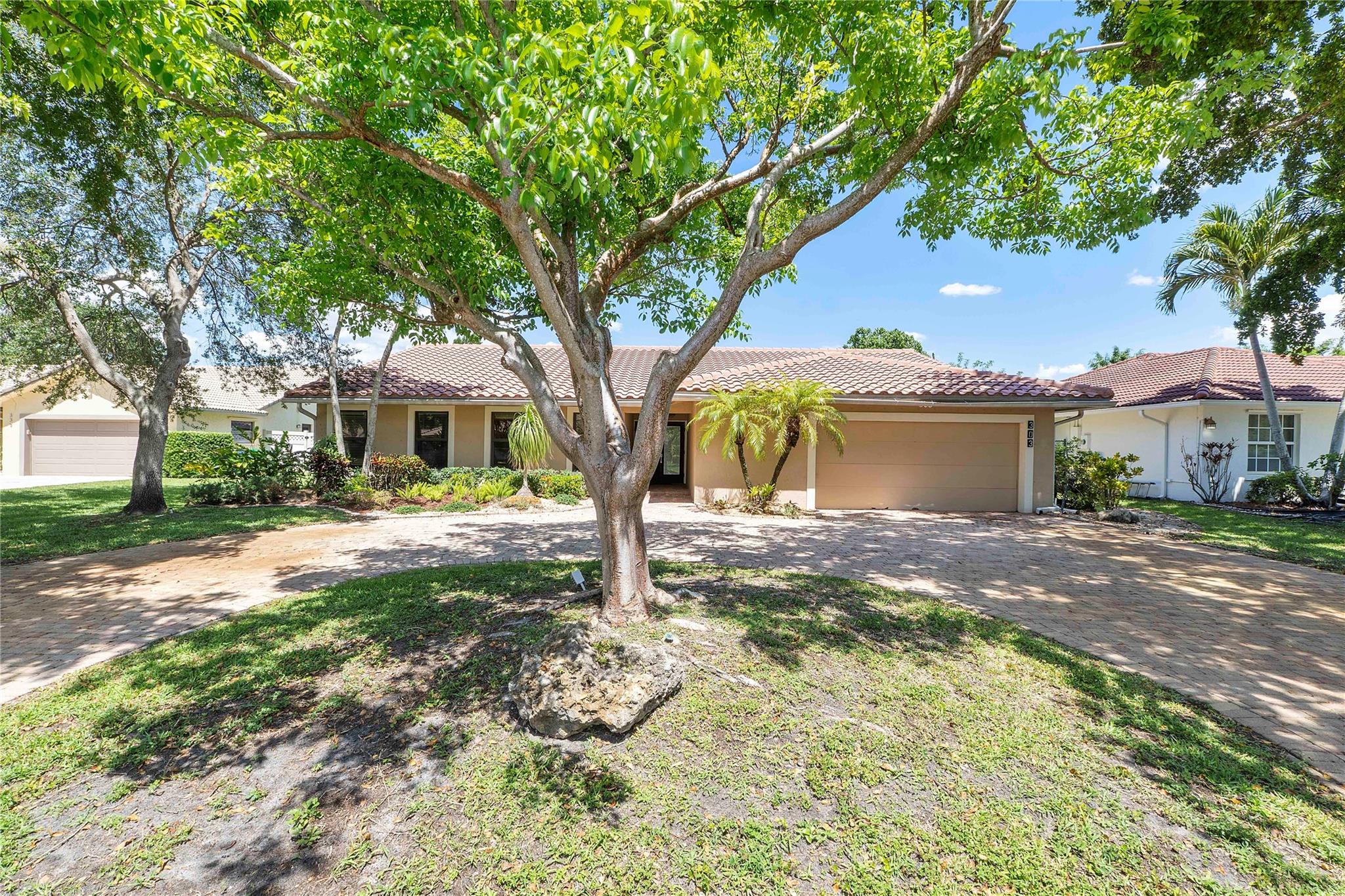 This stylish waterfront/pool home features 4 bedrooms, 3 baths, 2 car garage with a circular driveway. The large open kitchen boasts Quartz counters, SS appliances and glass top range/oven. Formal dining and living area. The family room and eat-in kitchen seamlessly opens to the backyard for unparalleled indoor and outdoor living. Double doors lead to a large primary with private bath, dual sinks, jetted tub step-in shower. Your backyard tropical oasis boasts a screened-in patio & sparking pool with secure child gate overlooking serene water views. Other features include 2019 AC, finished garage floor, lights and storage, built in electric touch screen fireplace, new washer/dryer front loaders. This home is a true gem. Schedule an appointment today.