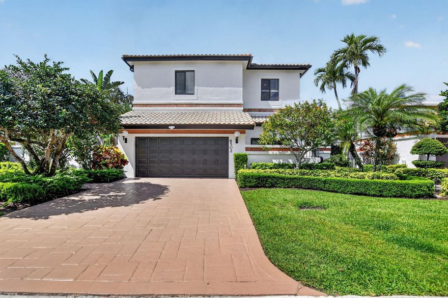 Rarely available, custom-built WATERFRONT ESTATE in the prestigious, 24/7 guard-gated Boca Pointe. This sophisticated residence offers an expansive and versatile 4BR/3BA plus DEN layout, designed for luxury and comfort. The architectural elegance is defined by grand cathedral ceilings and massive windows that illuminate the home with an abundance of natural light. The thoughtfully designed floor plan includes a convenient Main-Level Primary Suite and a secondary bedroom/bath on the first floor, with two additional bedrooms and a full bath upstairs—perfect for privacy and multi-generational living.Renovated for ultimate peace of mind, the home features 2025 COMPLETE IMPACT glass windows/doors, a 2025 new main A/C, and a 2024 water heater.  The exterior was freshly painted in 2026, including the driveway. Step outside to your private tropical paradise: a serene backyard featuring a relaxing heated JACUZZI overlooking tranquil lake views with a fountain. Located in an A-rated school district near luxury shopping and dining. Optional club membership is available for golf, tennis, and social amenities. A true move-in-ready masterpiece combining modern upgrades with timeless waterfront elegance.