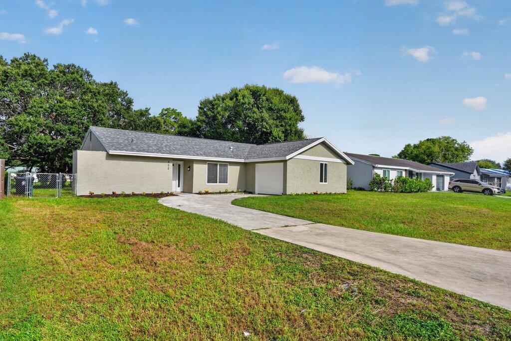 Photo of 302 SW Kentwood Road, Port Saint Lucie, FL 34953 (MLS # B26060486)