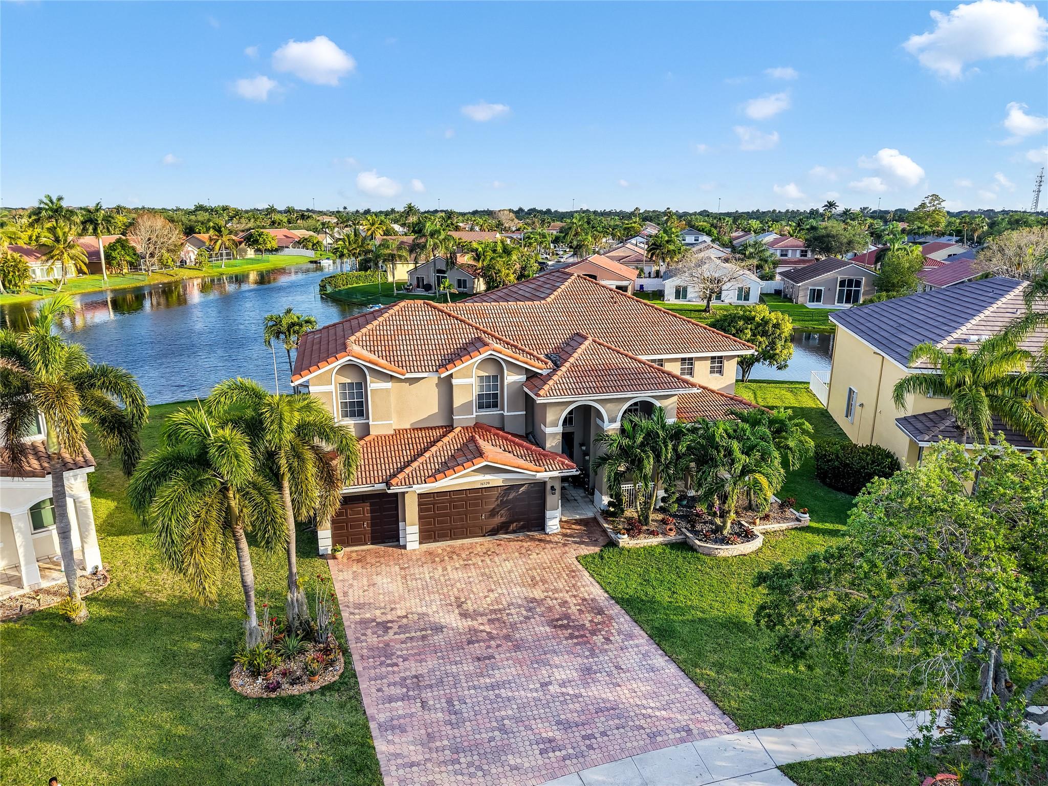 Welcome to this highly sought-after gated community in Spring Valley in West Pembroke Pines! This stunning 5-bedroom + loft, 3.5-bathroom home boasts an open floor plan, soaring ceilings, and a striking staircase. Enjoy breathtaking lake views and indoor-outdoor living with a private pool, spacious patio, and beautifully landscaped garden—perfect for entertaining or relaxing in your own private oasis. Conveniently located near Whole Foods, top-tier shopping, dining, and more, this home blends elegance with everyday convenience. Impact windows to be installed. Added features of this unit are an open air loft space and lovely balcony of the master bedroom.