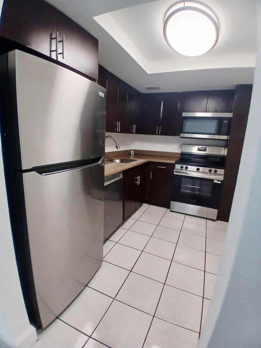 Large 3 bedroom 2 bath corner unit on 1st floor | Beautiful unit features European Designer Style Kitchen Cabinetry newer Stainless Steel Appliances| European styled Tiled Showers | Tiled Floor | Community Pool | Play ground |Conveniently located Close to Shopping , Dining , entertainment and Public Transportation.