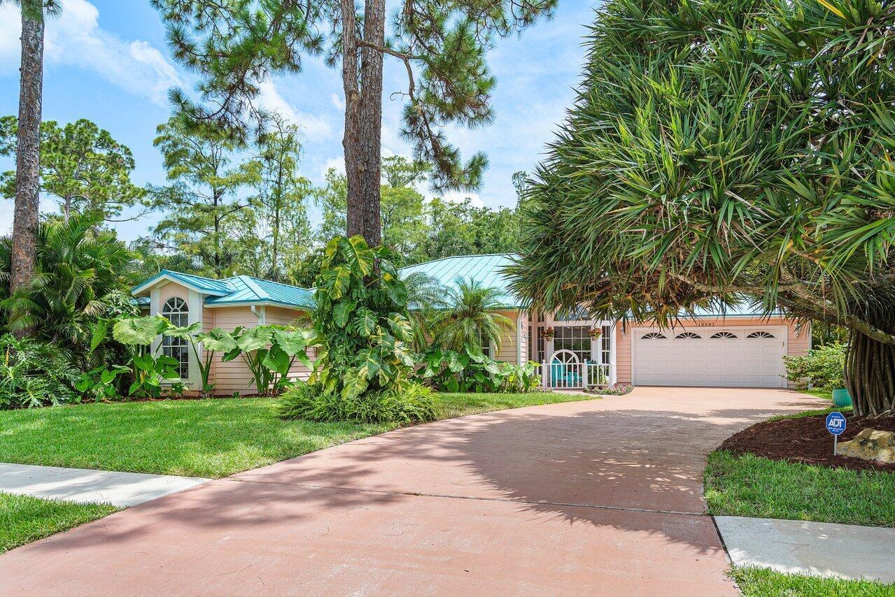 Beautiful and Unique 4 bed, 2 bath one story home lovingly cared for by the same family for over 30 yrs. Nestled among the mature trees, the house offers privacy in a park like setting. The roofed & screened patio has southern exposure and overlooks a lush fully fenced backyard with room for a pool. Bonus Metal roof, Lennox A/C 2024, long driveway and well irrigation system. Spectacular kitchen is gem of the house! It has a skylight, white quartz countertops, upgraded white wood, lighted cabinetry with glass doors and under cabinet lighting, an abundance of storage and pull out drawers, a large island with built in storage, a Kitchenaid cook top range, built in double ovens and dishwasher, a cafe door refrigerator, and a stainless steel sink. The tile back splash is a work of art......con